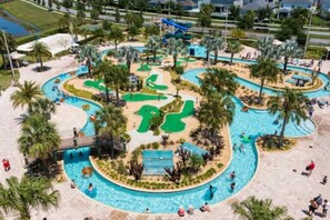 A water park with multiple pools, slides, and a winding path. - Gorgeous Home With Pool and Lake View (Kissimmee)
