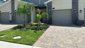 A modern two-story house with a driveway, a landscaped front yard, and a garage. - Fabulous 3 Bedroom With Game Room (Davenport)