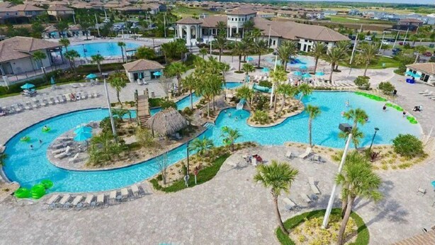 A resort with multiple swimming pools, palm trees, and lounge areas. - Fabulous 3 Bedroom With Game Room (Davenport)