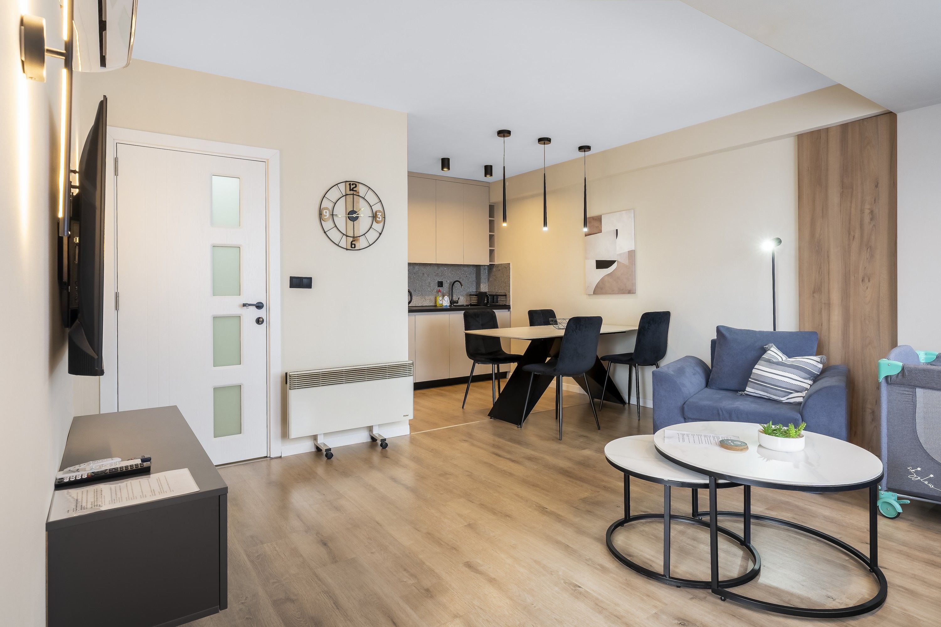 A modern living room with a round coffee table, a sofa, and a TV.
