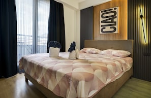 A modern hotel room with a large bed, a headboard, and a wall-mounted clock. - L&L Apartments - The Urban Loft Ohrid (Oher)