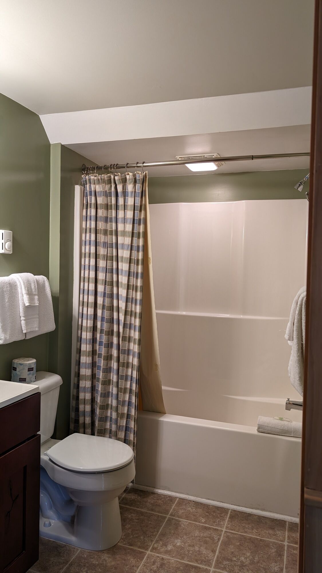 A bathroom with a toilet, a shower, and a bathtub.