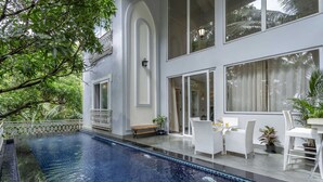 A modern house with a swimming pool, white furniture, and large windows. - Villa Jaanzu - 4bhk With Private Pool in Saligao (Calangute)