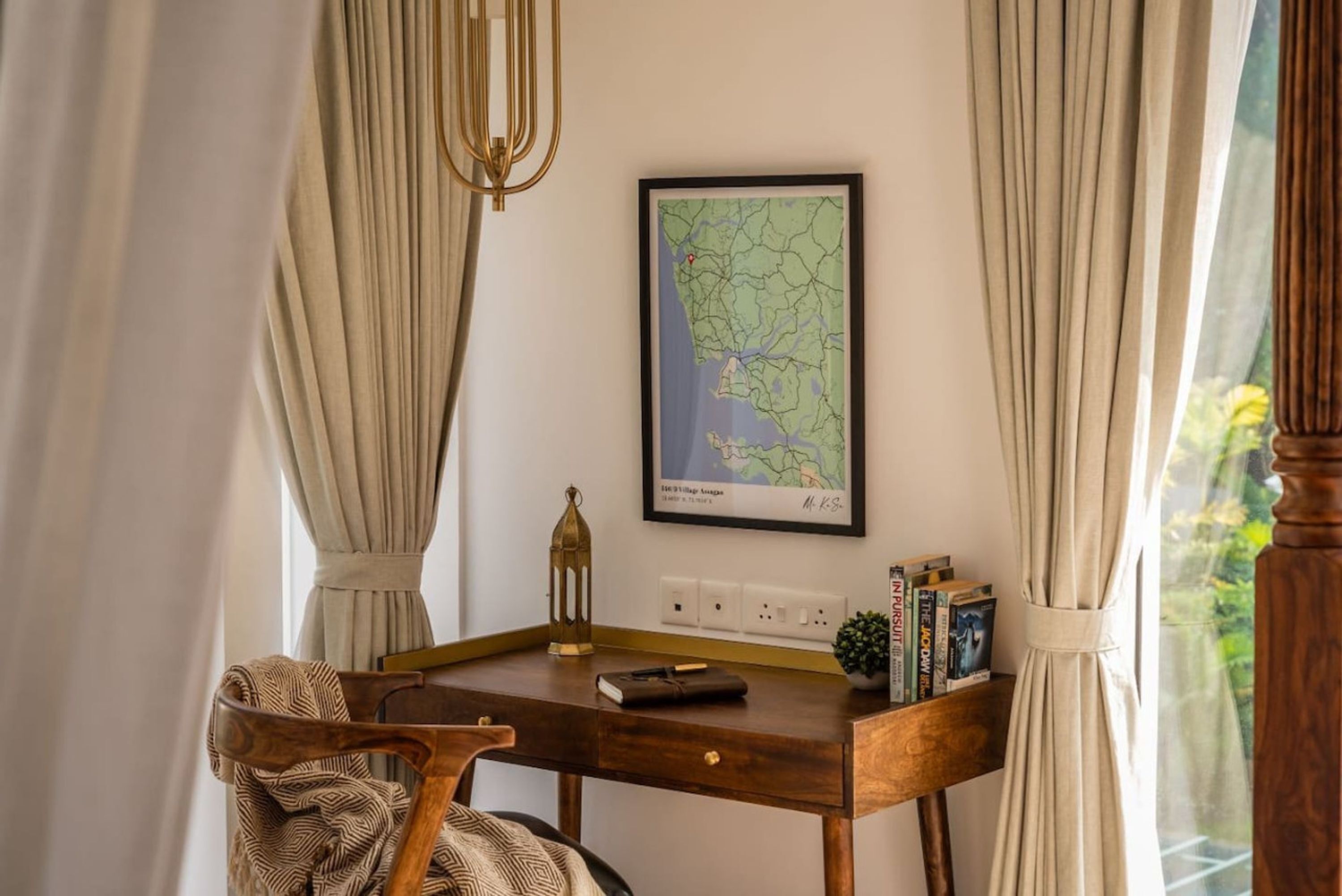 A wooden desk with a map, books, and a lantern.