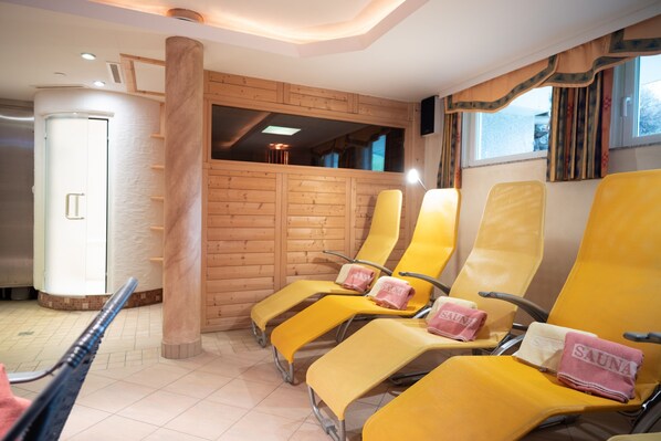 A sauna room with wooden walls, yellow chairs, and towels with 'SAUNA' written on them. - Haus Katharina - Dorfblick (Kaprun)