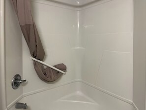 Combined shower/bathtub, towels, soap, toilet paper