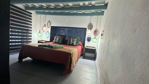 A bedroom with a bed, pillows, and bedside tables. - 340 Livingtarifa Warhol (Tarifa)