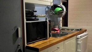 A compact kitchen with a microwave, a small sink, and a dishwasher. - Studio at the foot of the slopes/Mountaineering/Hiking accrobranche La Bresse (La Bresse)
