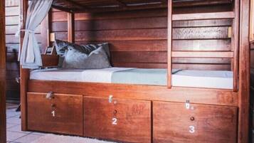 A wooden bunk bed with three drawers labeled 1, 2, and 3, and a single bed above.