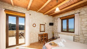 A bedroom with a bed, a desk, a chair, and a view of the outdoors. - Villa Hara Faragi - Three Bedroom Villa, Sleeps 7 (Crete)