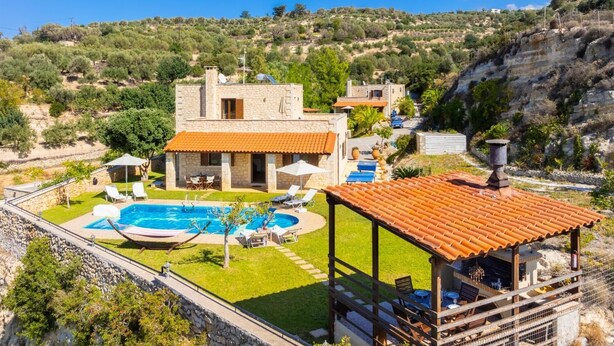 A stone villa with a swimming pool, outdoor seating, and a view of the surrounding hills. - Villa Hara Faragi - Three Bedroom Villa, Sleeps 7 (Crete)