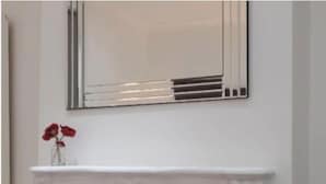 A fireplace with white mantel and a mirror above it. - Charming Tower Bridge House (London)
