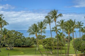 A tropical landscape with palm trees and a view of the ocean. - Island Surf 510A by Maui Rental Group (Kihei)