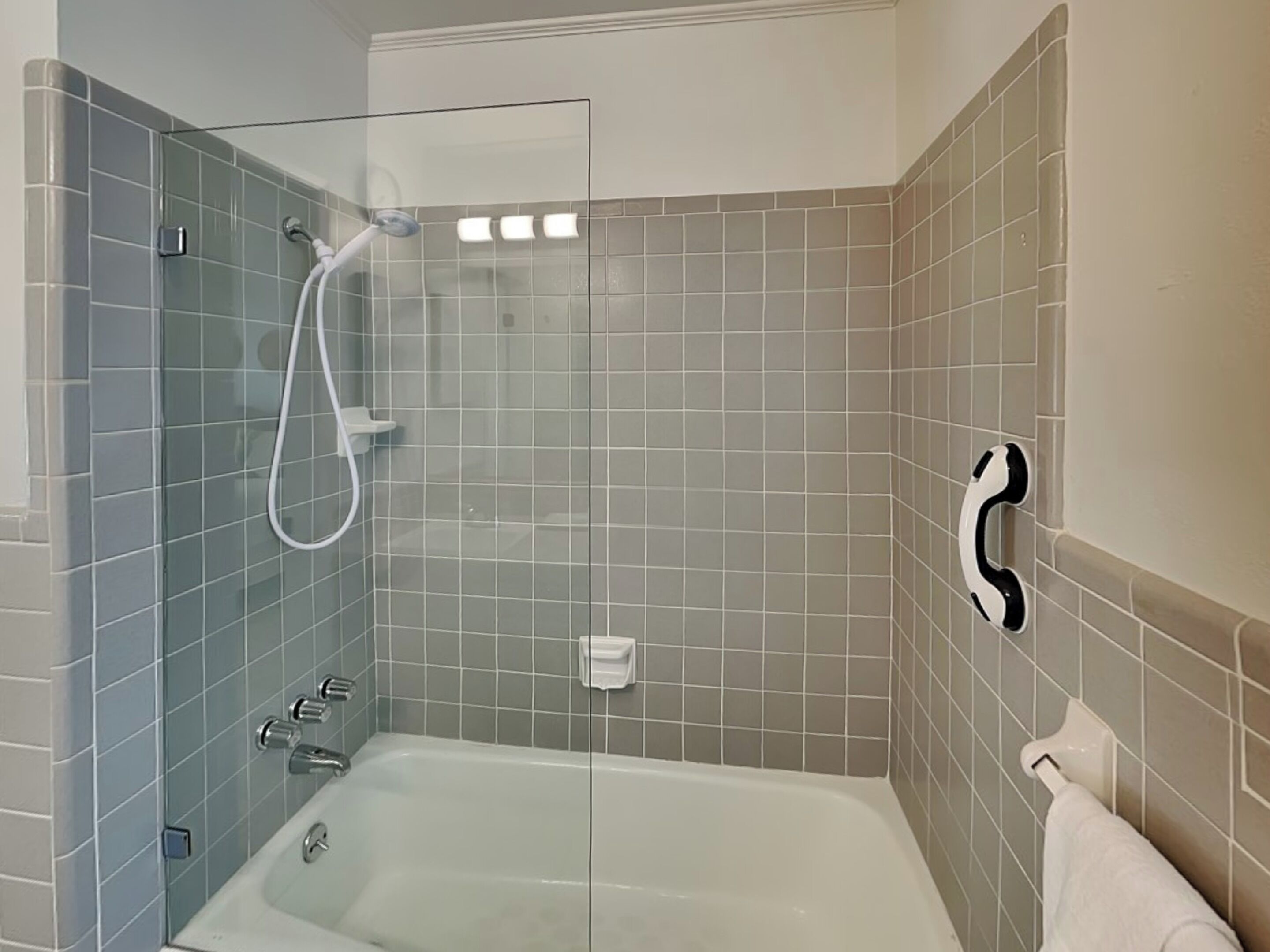 A bathroom with a glass-enclosed shower, a bathtub, and a toilet.
