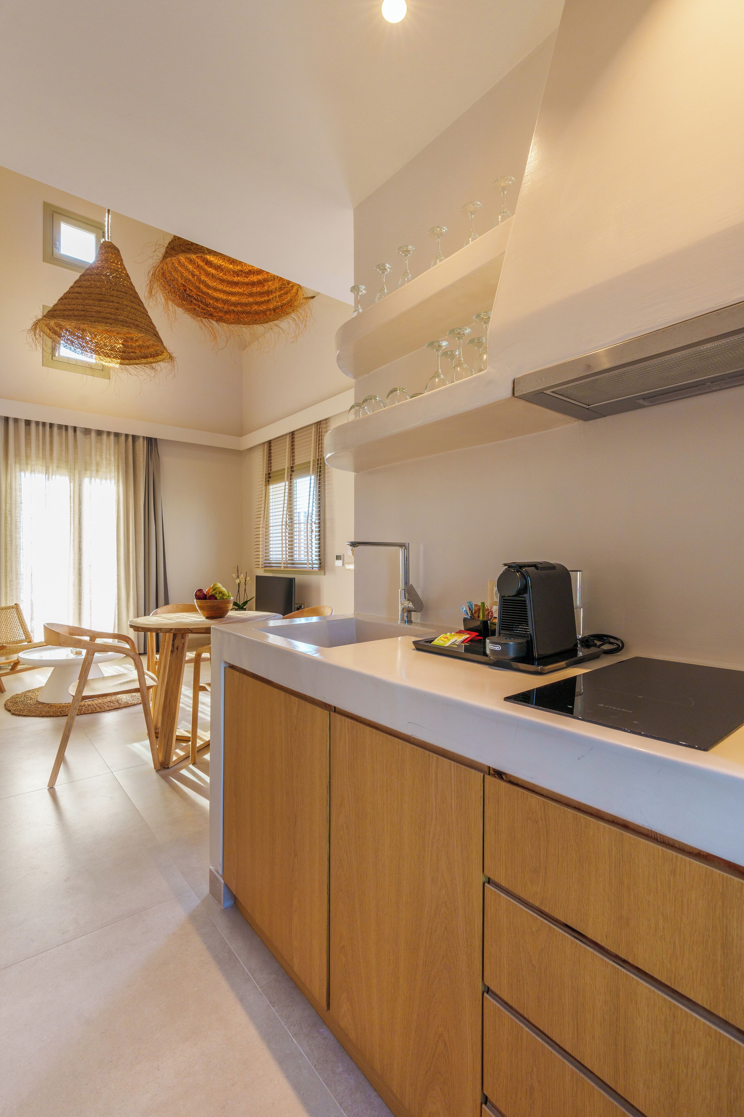 A modern kitchen with a central island, wooden cabinets, and a dining area with a table and chairs.
