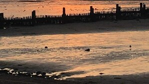 A sunset over a calm sea with a pier extending into the water. - Heacham Beach Caravan-sleeps 6-pets Ok-parking (King's Lynn)