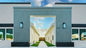 A modern building entrance with a clear pathway leading to a door marked with the number 3512.