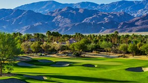 A golf course with a clear view of the mountains in the background. - End of Summer Golf Getaway | PGA West | Golf Cart (La Quinta)