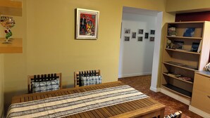 A bedroom with a bed, two chairs, a bookshelf, and a framed picture on the wall. - Cozy 2-bedroom apartment with WiFi, AC in amazing Penticton (Penticton)