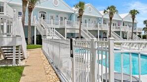 A beachfront hotel with multiple balconies, a pool, and a clear sky. - Waterfront 2BR Condo *Renovated 2025*  Marina Pool (Orange Beach)
