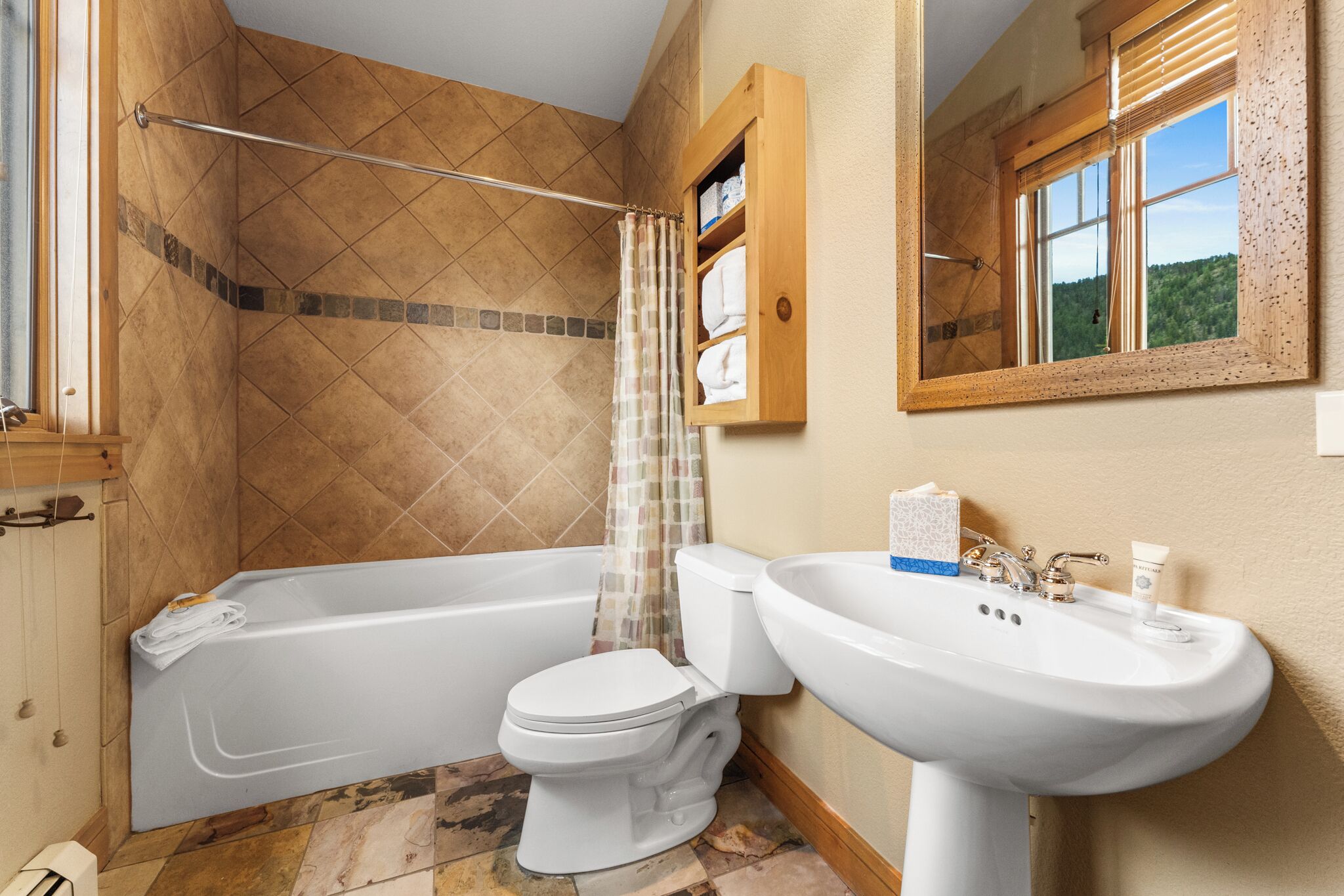 A bathroom with a bathtub, toilet, and sink.