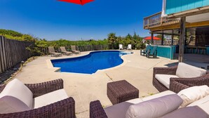 A swimming pool with lounge chairs and a bar area. - Back Bay Dog- Pool, Hot Tub, Bay, Sleeps 13 (Virginia Beach)