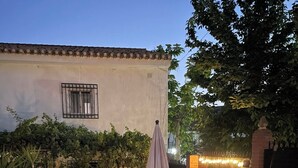 An outdoor patio area with seating, a pergola, and string lights. - Lovely 10-bed Villa With Private Pool & Garden (Cacin)