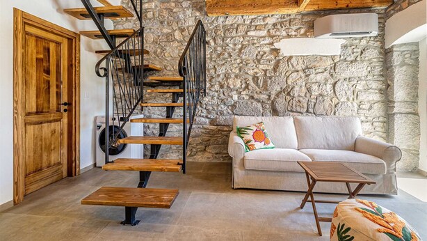 A rustic interior with a wooden staircase, stone wall, and a beige sofa. - Holiday house RURAL HOME FRANE (Kornić)