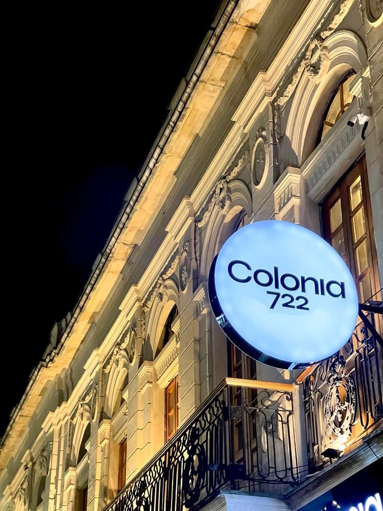 A building with a sign that reads 'Colonia 722' indicating the hotel's name and address.