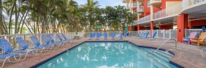 A pool area with blue lounge chairs and a clear blue pool. - Treasure Island Condo, 2 Bedroom, Across from Beach (Treasure Island)