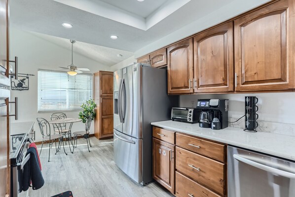 Enjoy meals in the well-lit kitchen with a dining area and modern appliances.