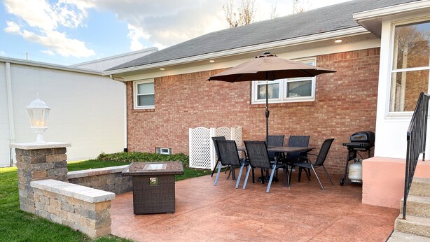 A patio with a table and chairs, a grill, and a fire pit. - Home Suite Home- Charming 3 BR 2B Home, Located in Erie- Presque Isle 1 Mile  (Erie)