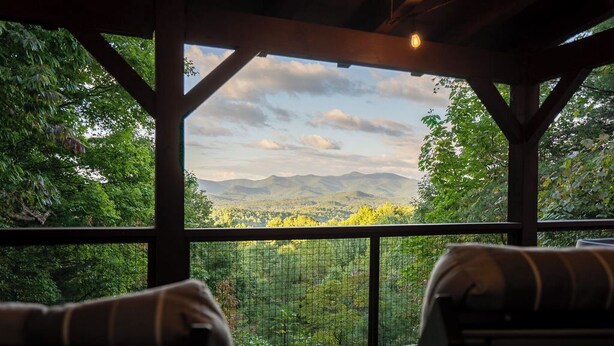 A covered outdoor seating area with a view of a mountainous landscape. - Cozy 2-bedroom cabin in beautiful Blairsville with AC, WiFi (Blairsville)
