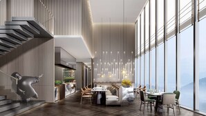 A modern restaurant with a high ceiling, vertical wooden slats, and large windows offering a view of the mountains. - Doubletree By Hilton Guang'An (Guang'an)