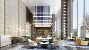 A spacious lobby with a high ceiling, a central seating area with sofas and chairs, and a large window providing a view of the outside. - Doubletree By Hilton Guang'An (Guang'an)