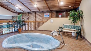 A hot tub area with a wooden ceiling, a bench, and a potted plant. - Champagne Powder Chalet! Best Ski In/Out at Big White. Sleeps up to 7ppl. (Beaverdell)
