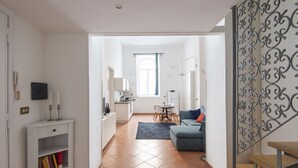 A modern apartment with a living room, dining area, and kitchen. - Vittorio Elegant Two Bedroom Apartment (Roma)