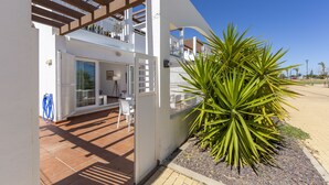 A modern house with a patio, a large plant, and a clear blue sky. - AlmeriaSuite Mojacar Breeze Sun101 (Mojacar)
