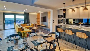 Um apartamento moderno com área de jantar, cozinha e sala de estar.