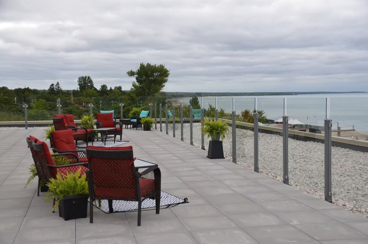 A patio with outdoor furniture and a view of the water.
