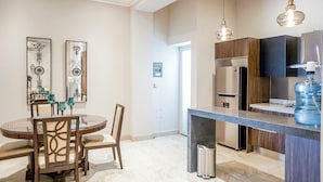 A modern kitchen with a central island, stainless steel appliances, and pendant lighting.