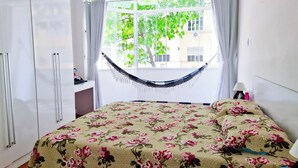 A bedroom with a bed, a hammock, a desk, and a wardrobe. - Copacabana Comfort Home (Rio de Janeiro)