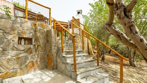 A stone staircase with wooden railings leading to a building. - Pintada by Interhome (Villasimius)