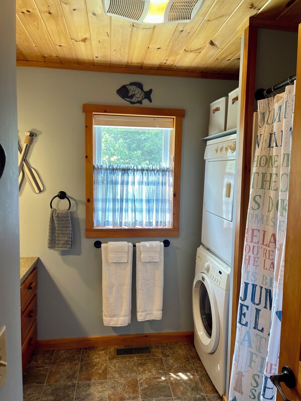 A laundry room with a washing machine, a drying rack, and a window with curtains. - Lake front year round home on beautiful Willsboro Bay, Lake Champlain (Willsboro)