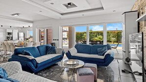 A modern living room with two sofas, a coffee table, and a TV. - Villa Mersi (Istria - Pula) (Pula)