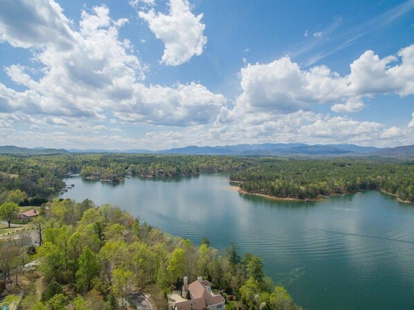 A lake surrounded by dense forest and mountains. - Birdsong | Fire Pit & Easy Access to Lake James! (Nebo)