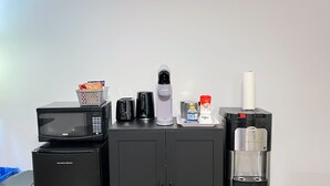 A kitchenette with a microwave, coffee maker, toaster, and a water dispenser. - Entire Guest Suite/Separate Entrance/Free Parking in Winnipeg (Winnipeg)