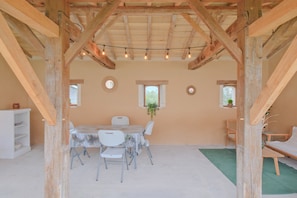 A rustic wooden interior with a dining table, chairs, and a sofa. - Holiday Home 'Gîte Le Moutat-Chez Georges' with Private Terrace (Allemans)