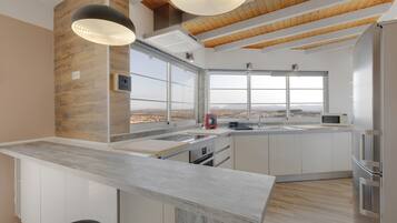 Fridge, microwave, coffee/tea maker, cookware/dishes/utensils