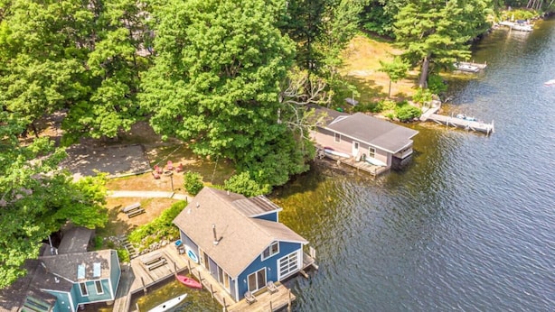 A lakeside property with a dock, a house, and a boat.
